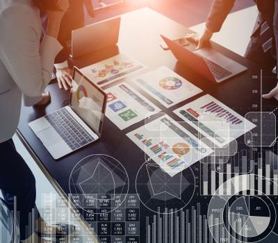 team of staff review colorful charts on a desk