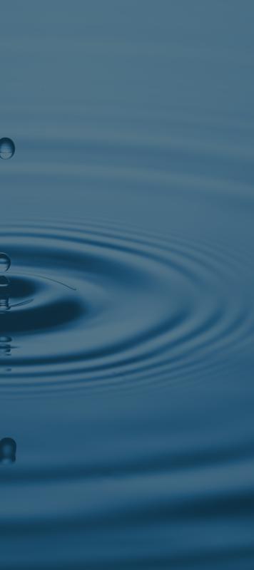 drops of water fall into a larger pool of water