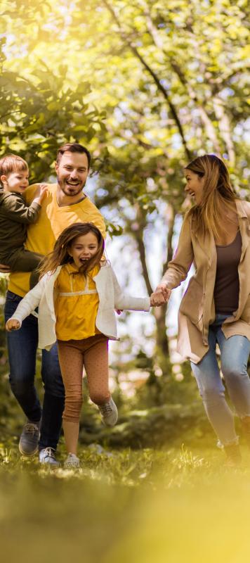 young family hikes in a lush park
