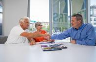 retiree couple meets with counselor in bright office