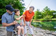 grandparents fish with young boy