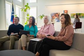 four retirees listen to a presentation