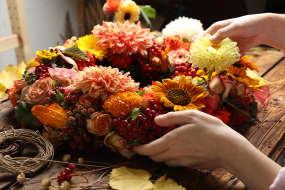 hands making fall wreath