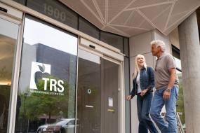 two retirees walk into TRS building
