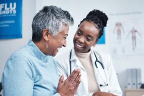 senior patient talks to doctor in bright office
