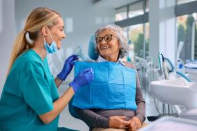 woman smile at dental technician in bright room