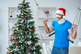 christmas tree and man in santa hat with crutches