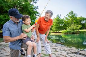 grandparents fish with young boy