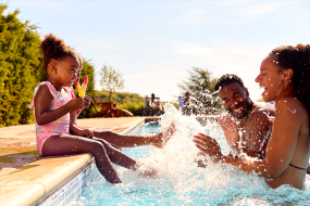 family splashing in pool