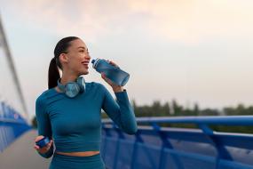 woman drinking from water bottle