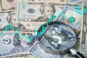 Dollars under magnifying glass 