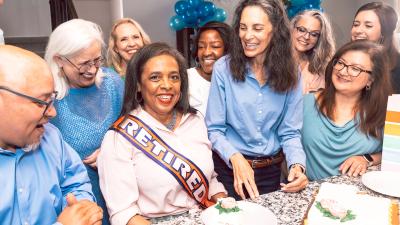 several friends at a retirement party with cake