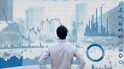 man stands at giant display of data