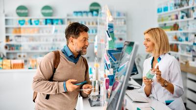 man in pharmacy talking to female pharmacist at the counter