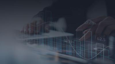 hand computing investment data on desk