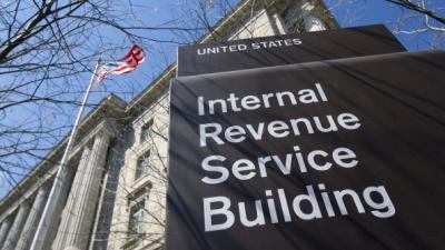 large sign in front of building that reads Internal Revenue Service Building