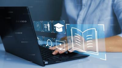 man types on laptop that shows training and learning icons