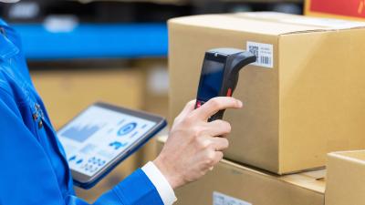 hand holds scanner up to label on package