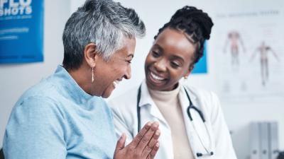 senior patient talks to doctor in bright office