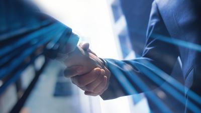 two professionals shake hand in commerce center