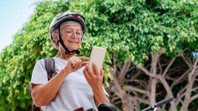 woman checking her phone on break from cycling