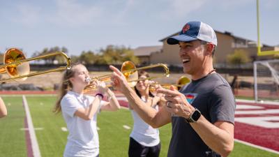 band director conducts female horn players