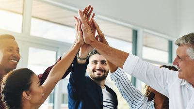 coworkers high five in celebration