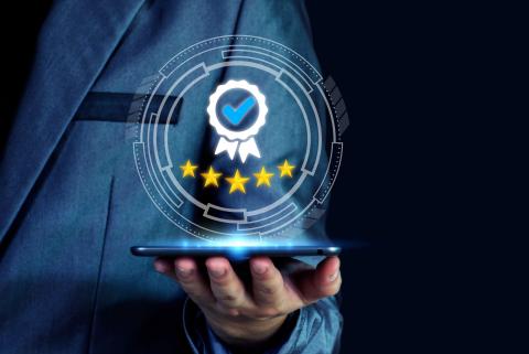 hand holding device that has 5 stars hovering above