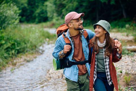 young couple on a fall hike with backpacks