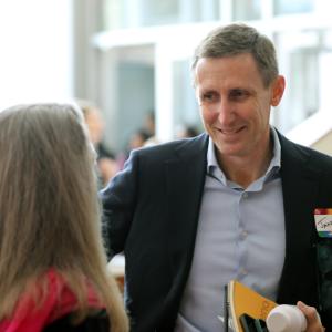 coworkers talk in busy lobby