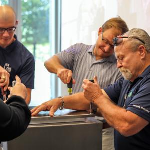 four employees seal up the TRS time capsule