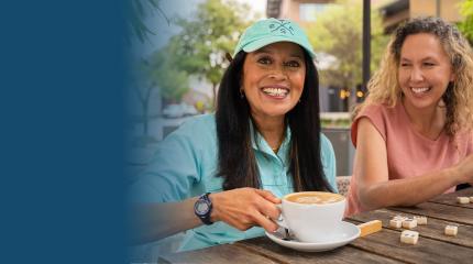 three women play mahjong and drink coffee outside