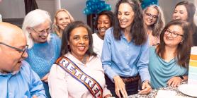 several friends at a retirement party with cake