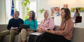 four retirees listen to a presentation