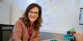 teacher grades papers at her desk