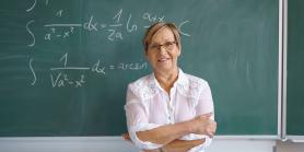 professor in front of chalkboard with math equations