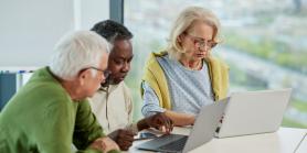 retirees meet with books and laptops