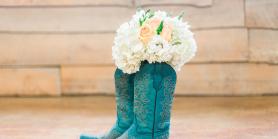 teal cowboy boots with bouquet of white flowers