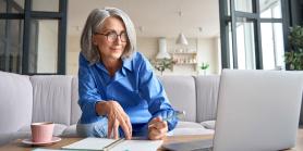woman meets with counselor via laptop computers