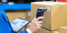 hand holds scanner up to label on package