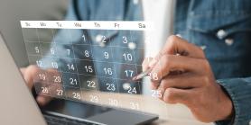 man's hand points to a date on a floating calendar