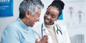 senior patient talks to doctor in bright office