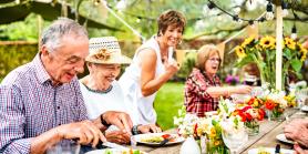 friends enjoy lunch outside with a lovely table spread