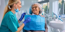 woman smile at dental technician in bright room