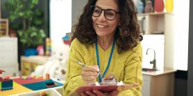 kindergarten teacher with lanyard in colorful classroom