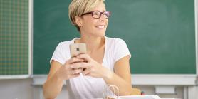 teacher on mobile phone during lunch break in class