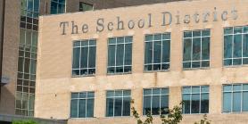 building with sign that reads school district