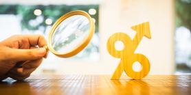 magnifying glass examines percent rate