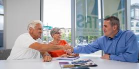 retiree couple meets with counselor in bright office