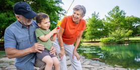 grandparents fish with young boy